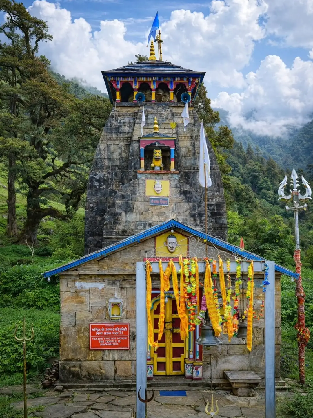 Madmaheshwar Temple surrounded by Himalayan mountains in Uttarakhand
